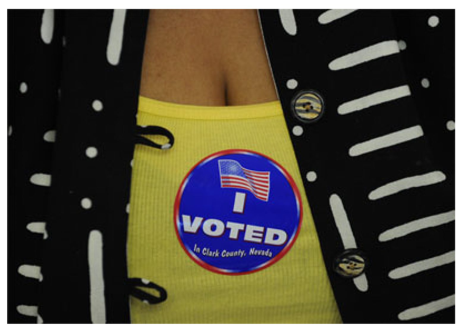 I voted sticker on a yellow top worn by a woman